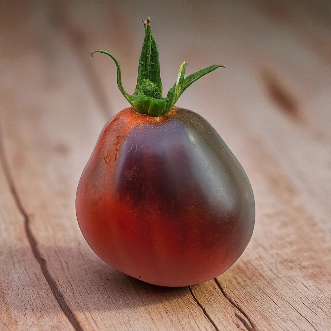 Blue Pear tomato on a wooden surface